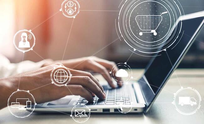 Manos de una persona usando un ordenador portátil con símbolos de e-commerce